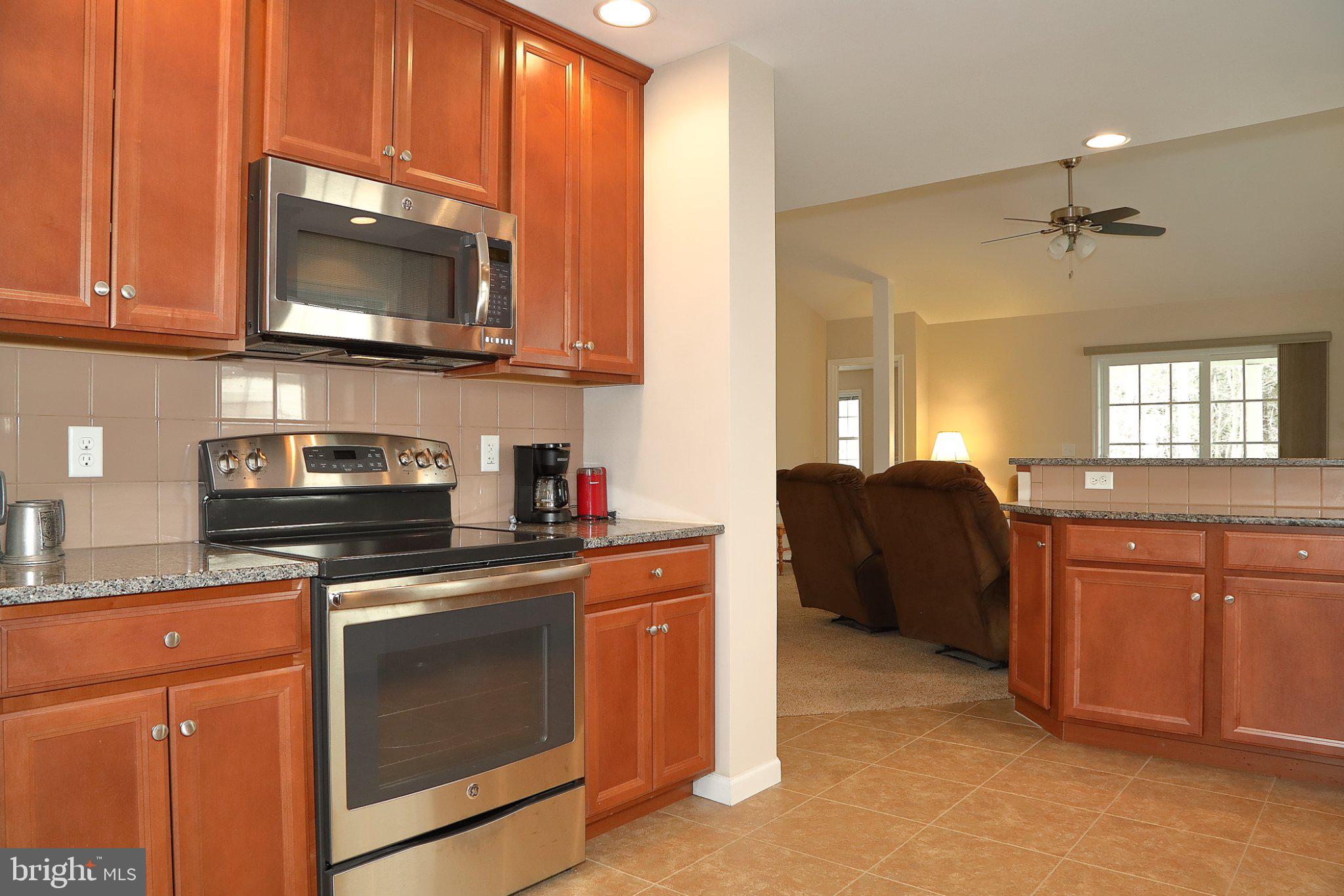 185 Waypoint Drive, Unit 236 Lancaster, PA 17603 - Photo 8 of 31 Modern kitchen with warm wood tones.