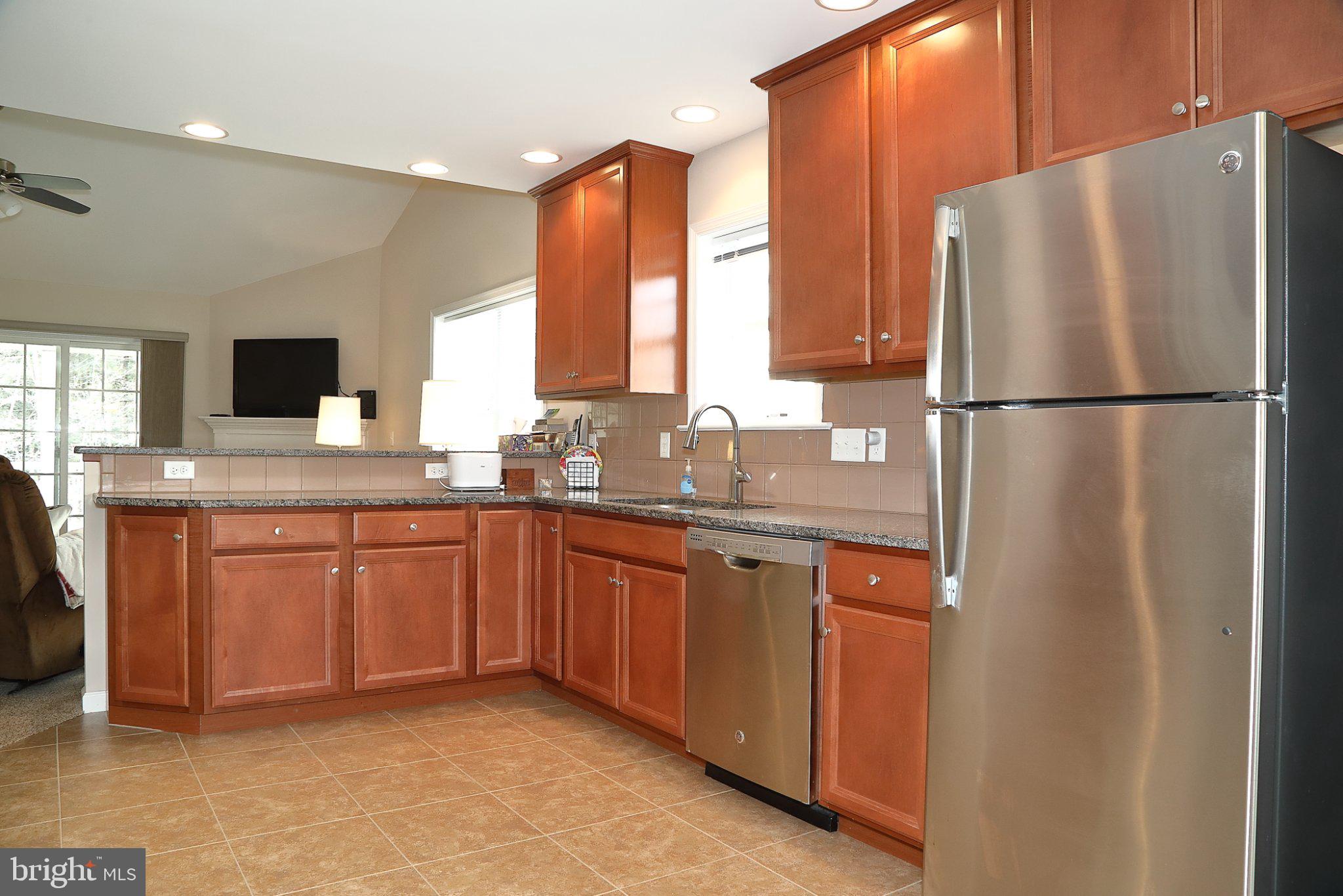 185 Waypoint Drive, Unit 236 Lancaster, PA 17603 - Photo 9 of 31 Modern kitchen with warm wood tones.