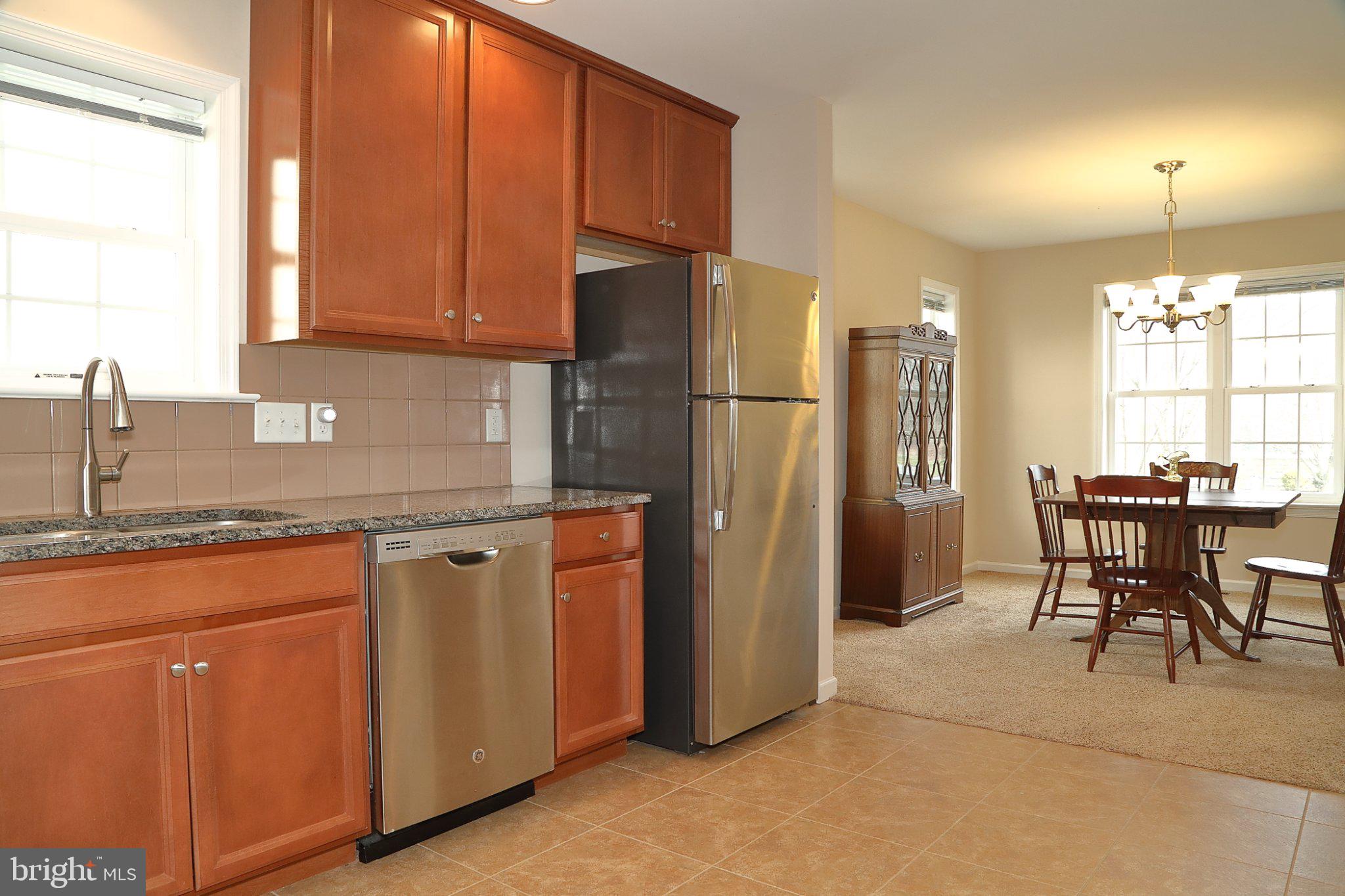 185 Waypoint Drive, Unit 236 Lancaster, PA 17603 - Photo 10 of 31 Modern kitchen with warm wood tones.