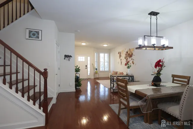 a kitchen with refrigerator cabinets dining table and chairs
