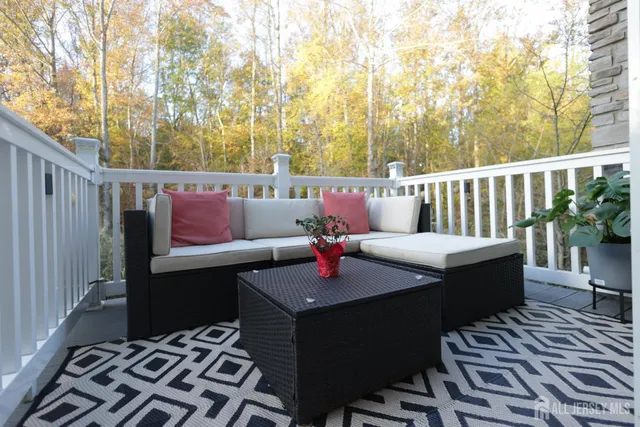 a bed sitting in a spacious bedroom next to a window and dresser