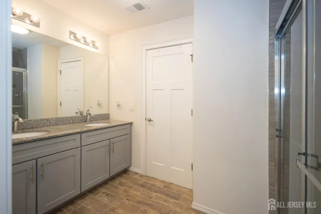 a bathroom with a glass shower door