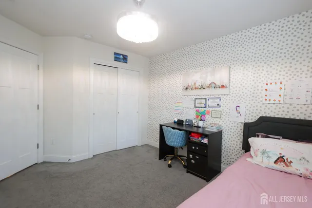 a bedroom with a bed and a desk