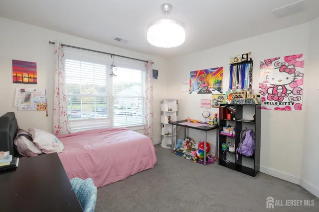 a bedroom with a bed and a chair