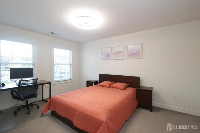 a bed sitting in a bedroom next to a window