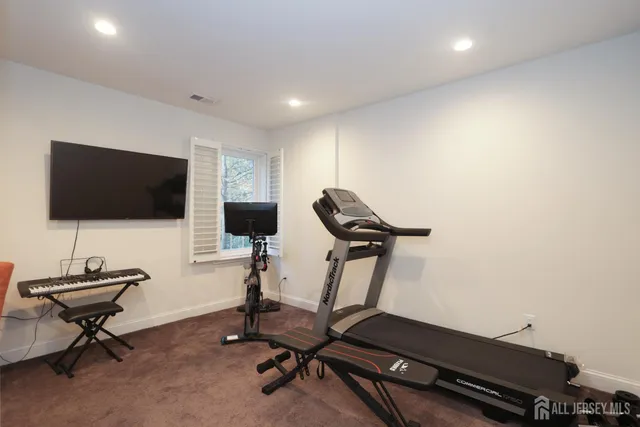 a dining room with furniture and a gym equipment