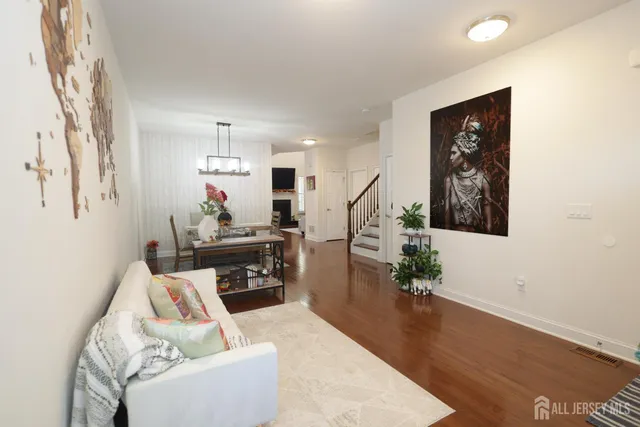 a living room with furniture and wooden floor