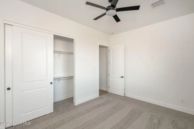 a view of a room with a ceiling fan