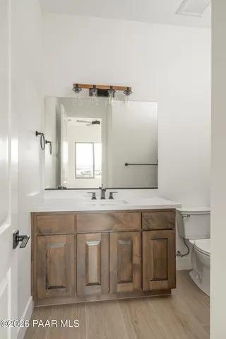 a bathroom with a sink a toilet and a mirror