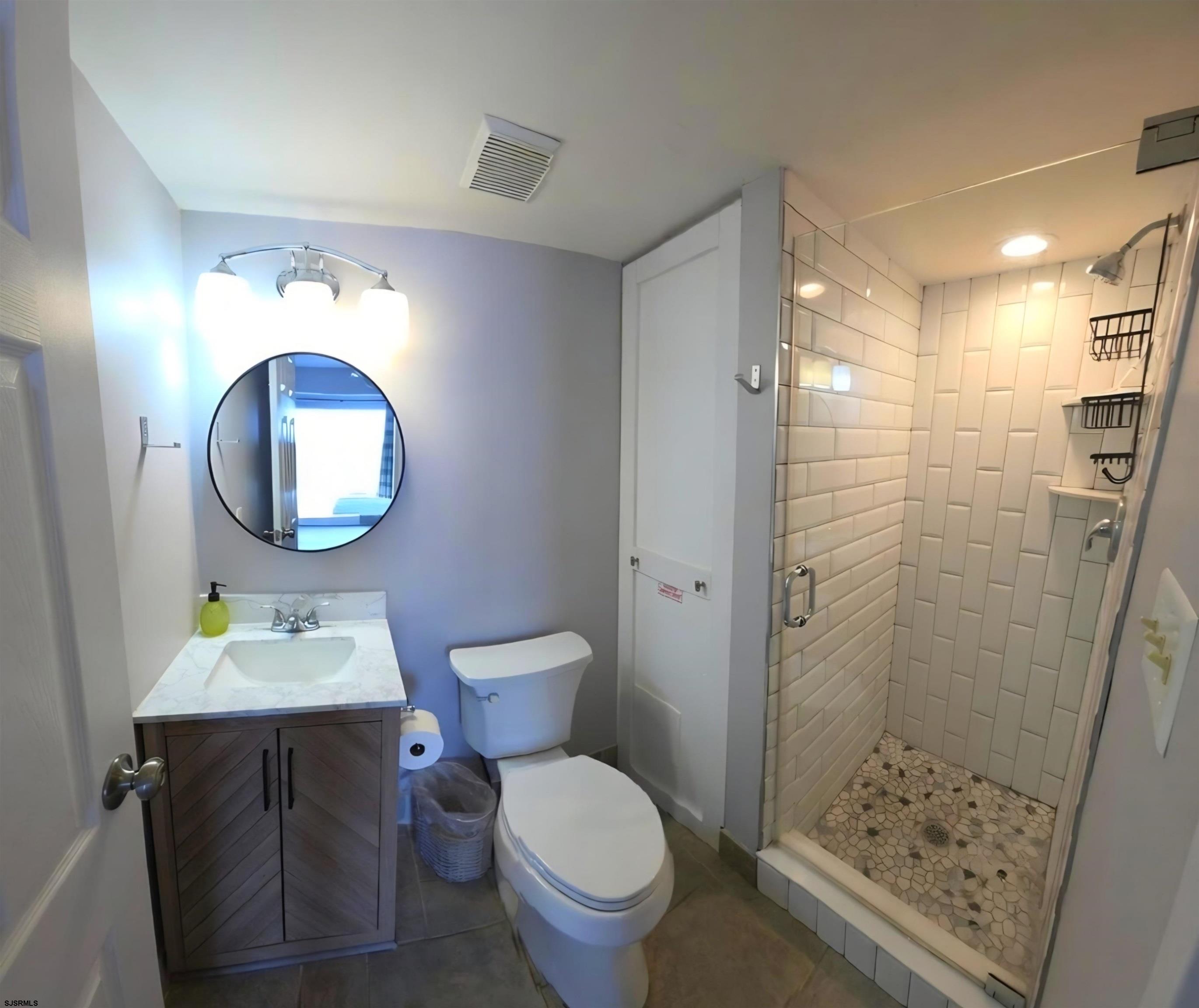 700 East Brigantine Avenue, Unit 2D Brigantine, NJ 08203 - Photo 12 of 21 a bathroom with a toilet a sink and a mirror