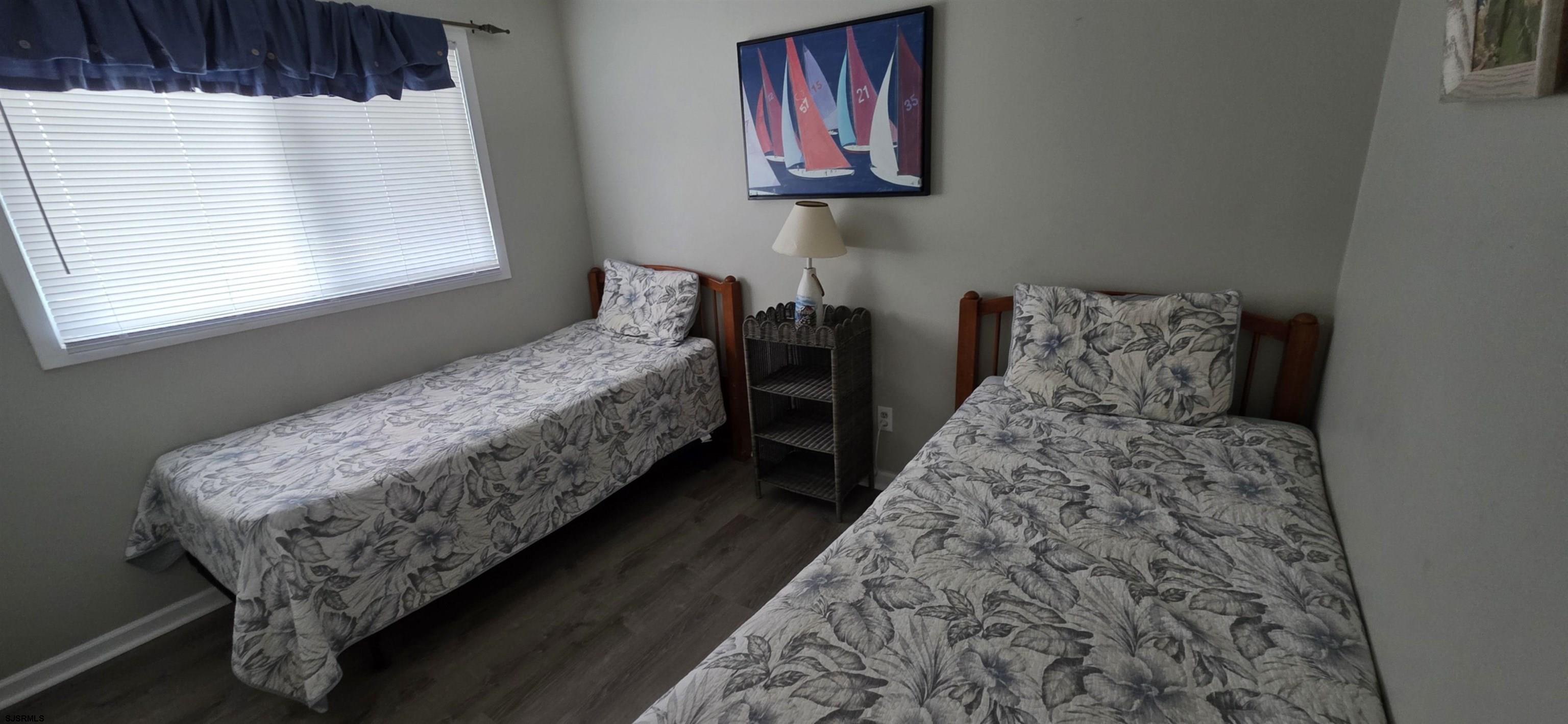 700 East Brigantine Avenue, Unit 2D Brigantine, NJ 08203 - Photo 13 of 21 a bed sitting in a bedroom next to a window
