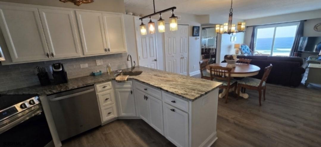 700 East Brigantine Avenue, Unit 2D Brigantine, NJ 08203 - Photo 3 of 21 a kitchen with granite countertop white cabinets and refrigerator