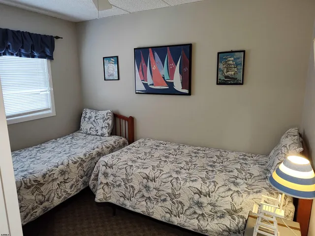 a bedroom with bed and painting on the wall