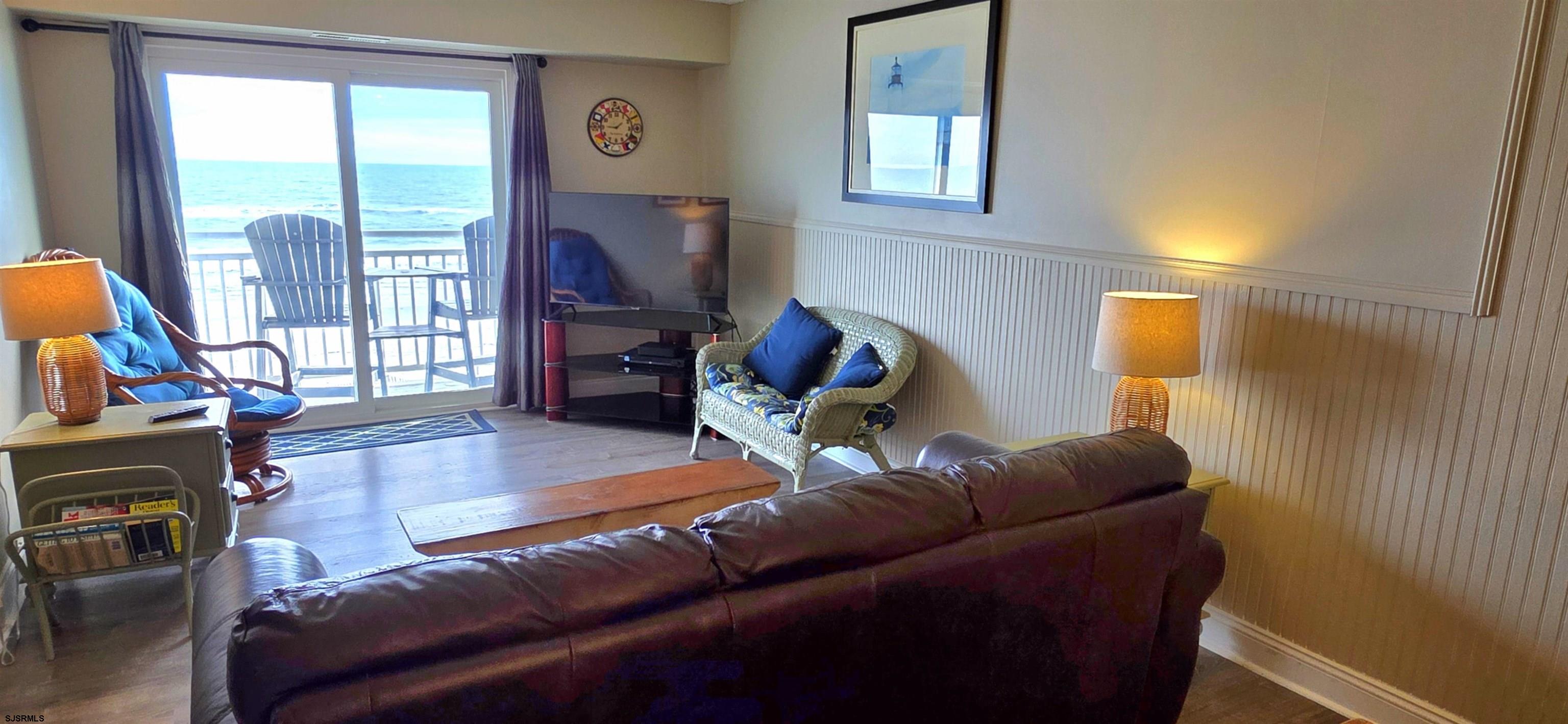 700 East Brigantine Avenue, Unit 2D Brigantine, NJ 08203 - Photo 7 of 21 a living room with furniture a flat screen tv and a window