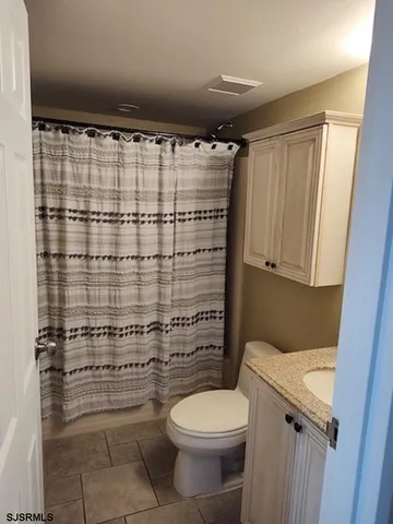 a bathroom with a toilet and shower
