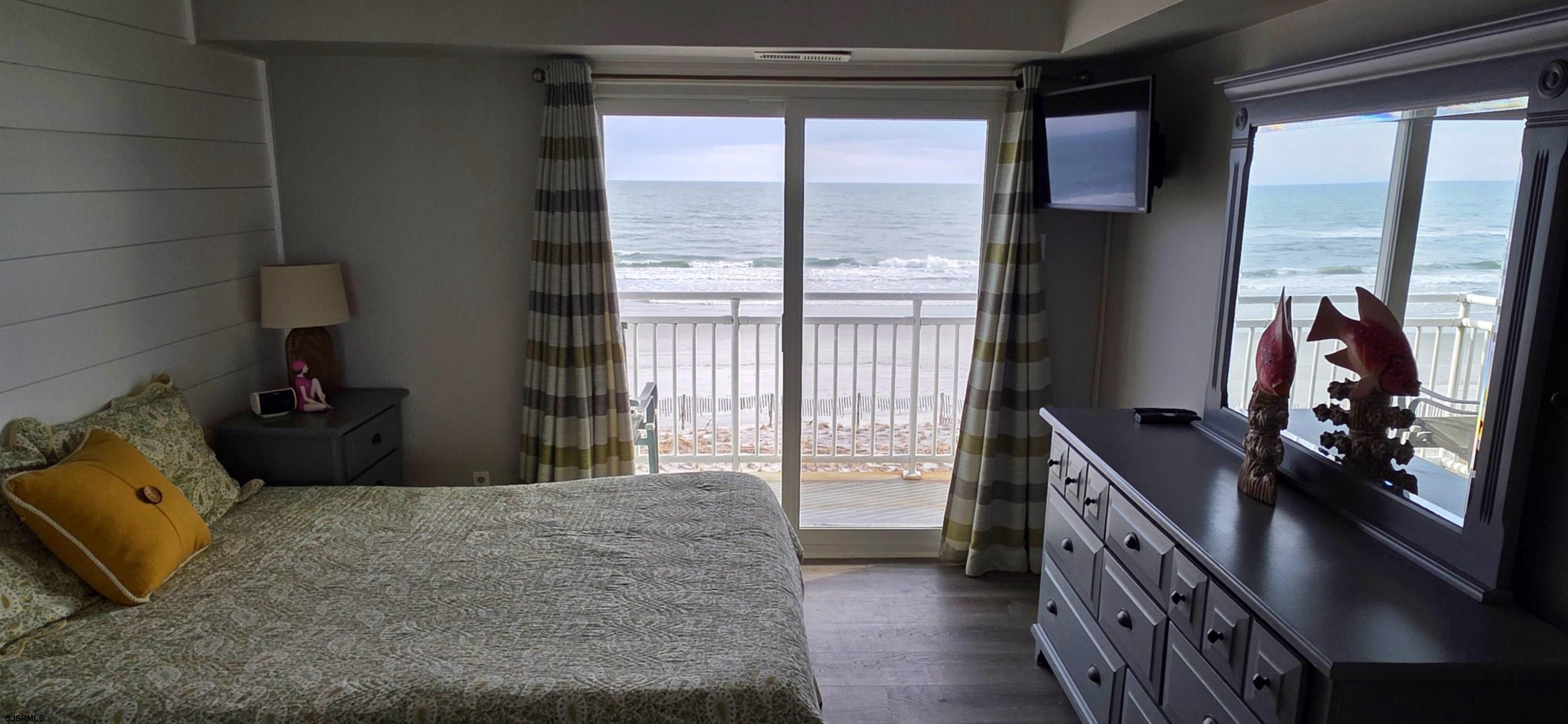 700 East Brigantine Avenue, Unit 2D Brigantine, NJ 08203 - Photo 9 of 21 a bedroom with a bed and large windows