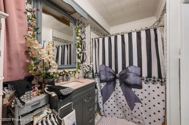 a bathroom with a sink a mirror and a shower