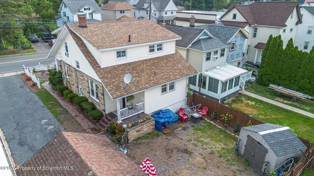 an aerial view of a house with swimming pool and porch