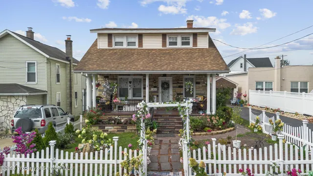 a front view of house with deck and outdoor seating