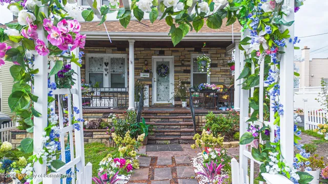 a front view of a house with a yard and fountain