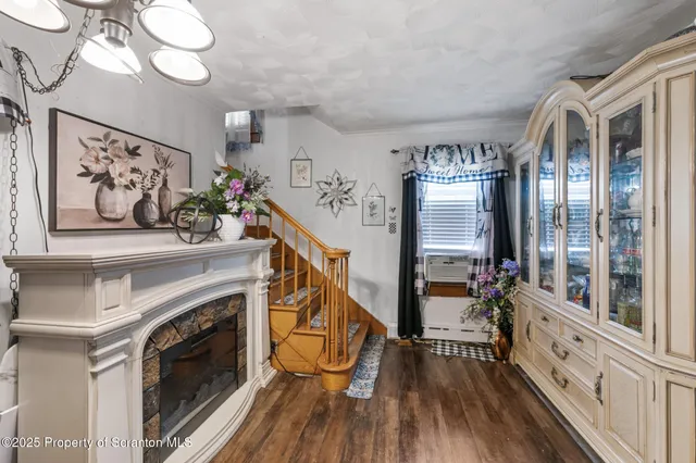 a very nice looking room with many windows and a fireplace