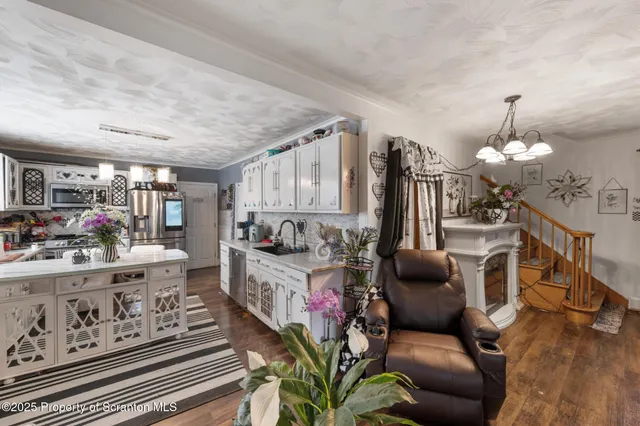 a living room with furniture and a chandelier