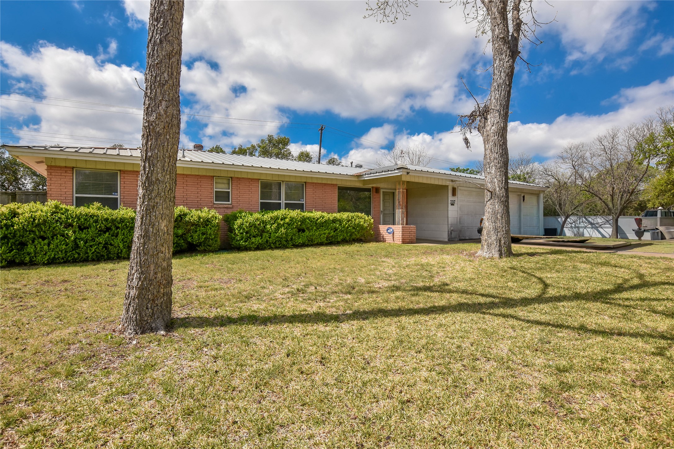 3317 Bosque Lane Austin, TX 78754 - Photo 1 of 18 a view of a house with a yard and potted plants