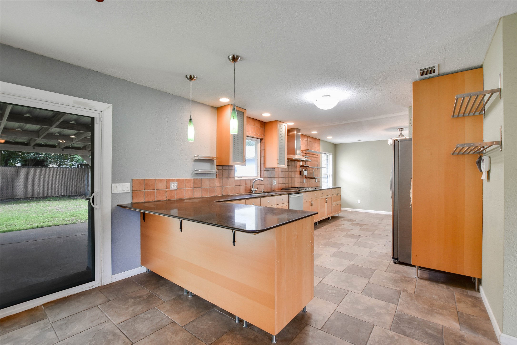 3317 Bosque Lane Austin, TX 78754 - Photo 11 of 18 a kitchen with stainless steel appliances granite countertop a sink and a refrigerator