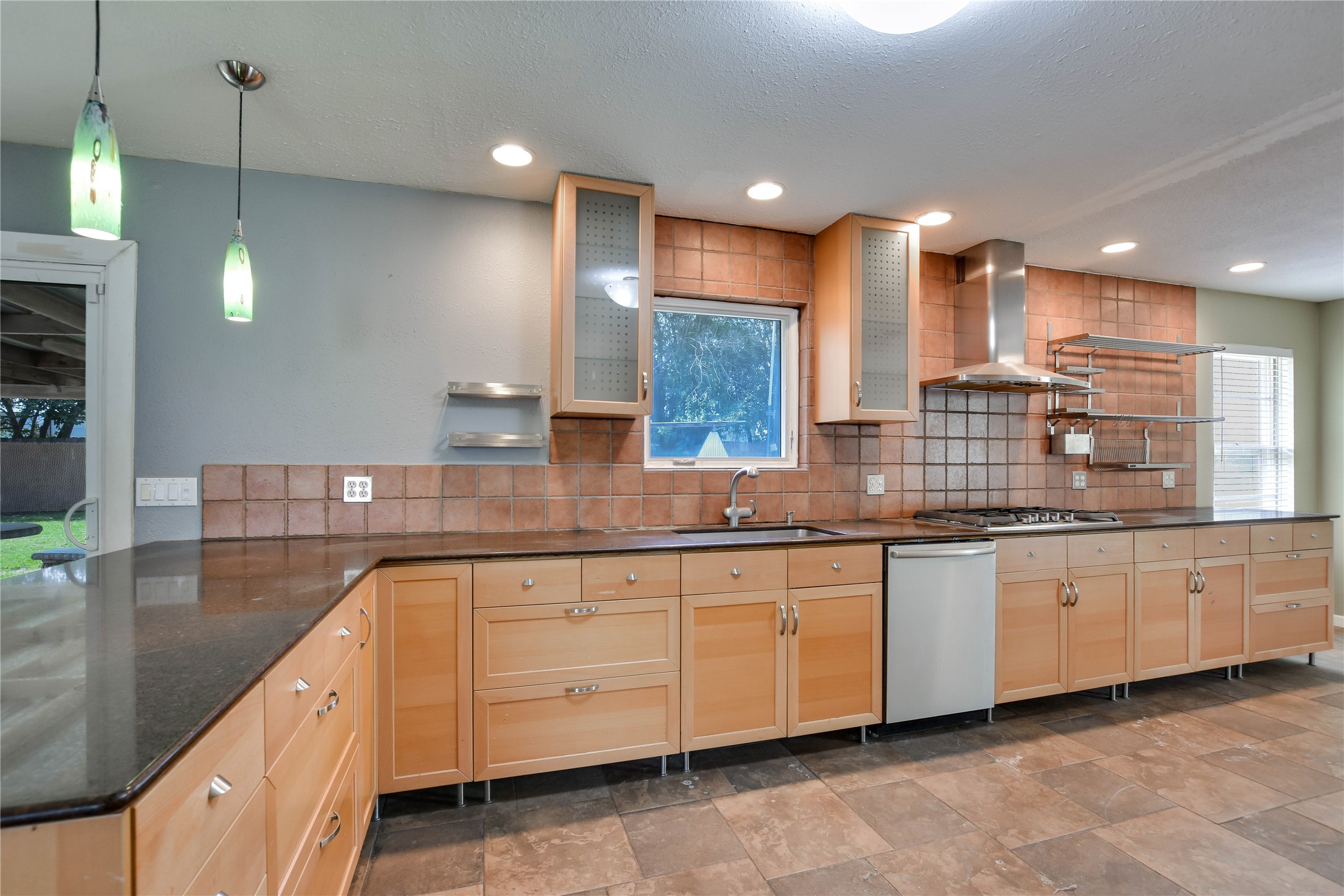 3317 Bosque Lane Austin, TX 78754 - Photo 12 of 18 a large kitchen with granite countertop a sink and white cabinets