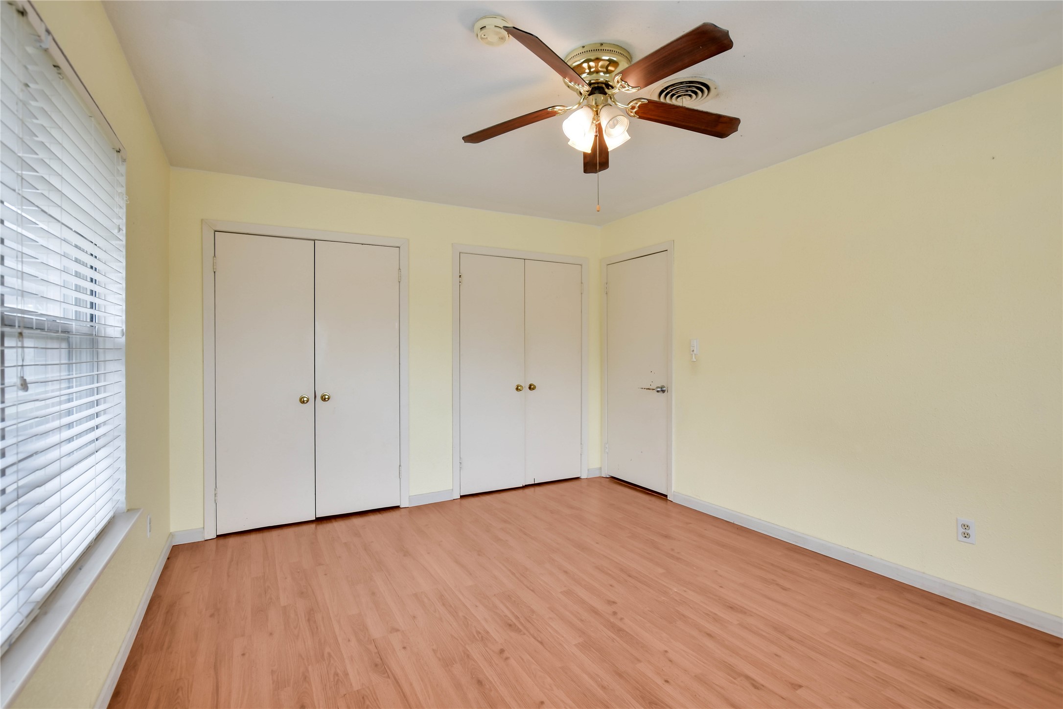 3317 Bosque Lane Austin, TX 78754 - Photo 16 of 18 an empty room with wooden floor fan and windows