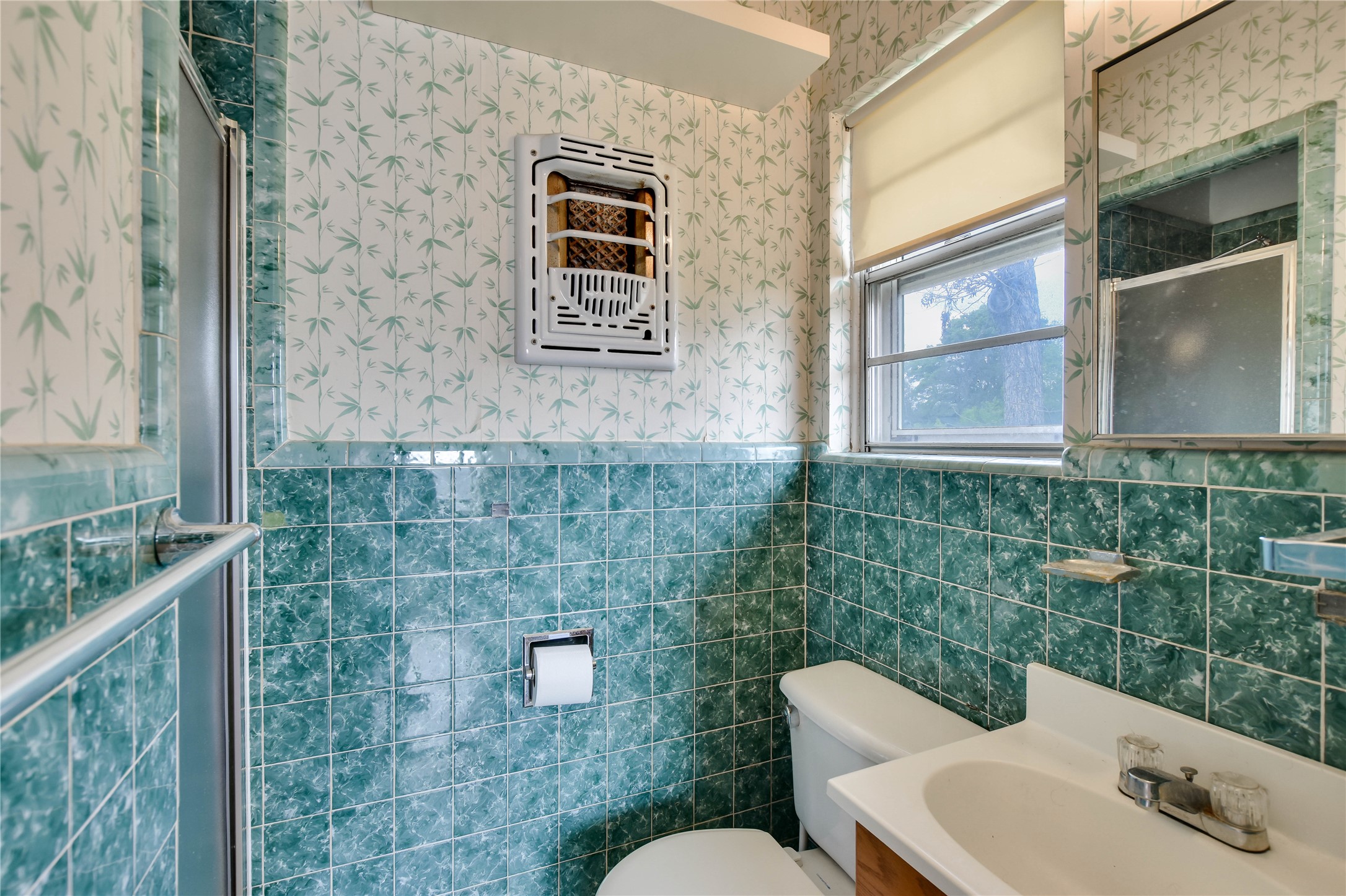 3317 Bosque Lane Austin, TX 78754 - Photo 18 of 18 a bathroom with a toilet sink and mirror
