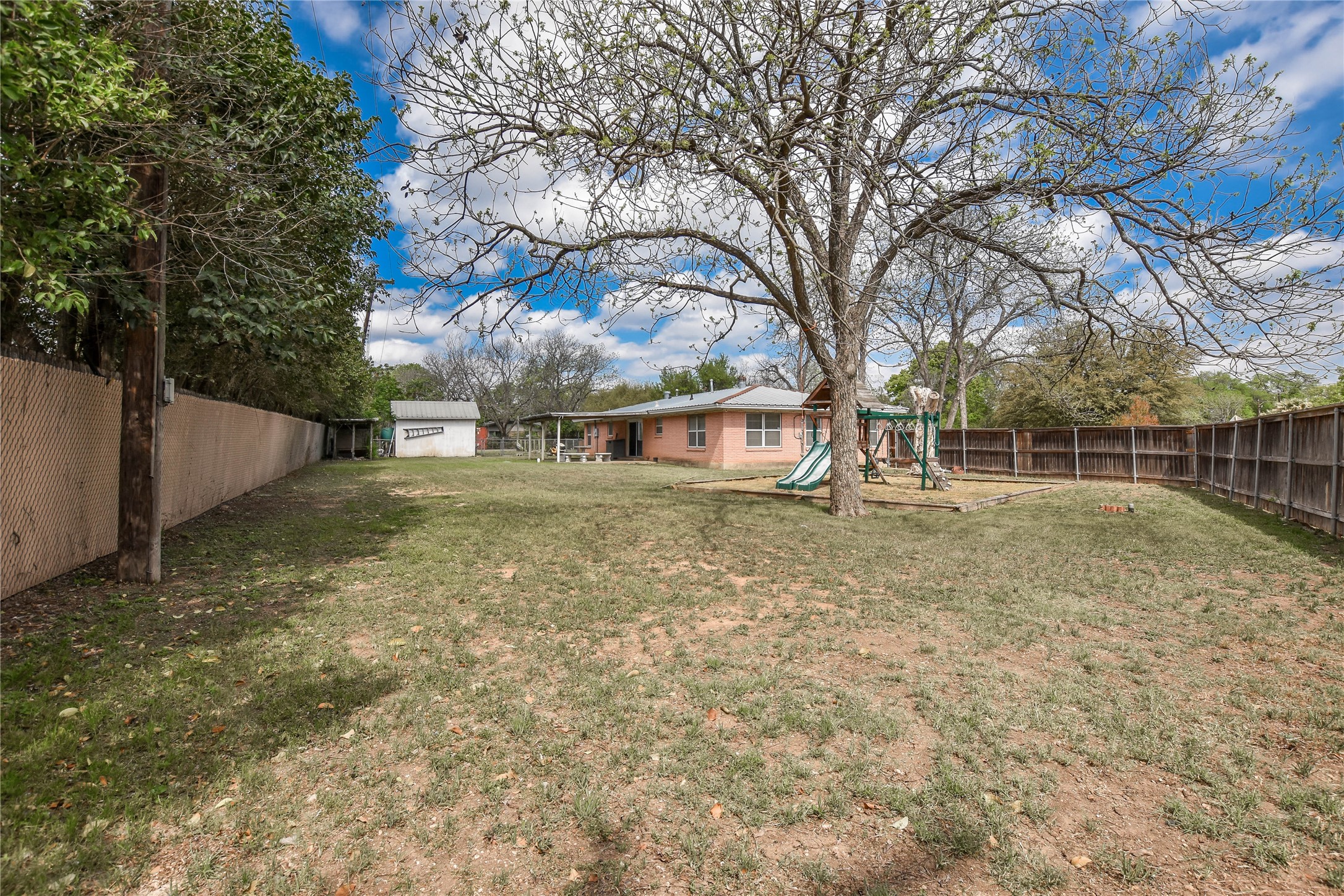 3317 Bosque Lane Austin, TX 78754 - Photo 6 of 18 a view of a yard with a house and a large tree