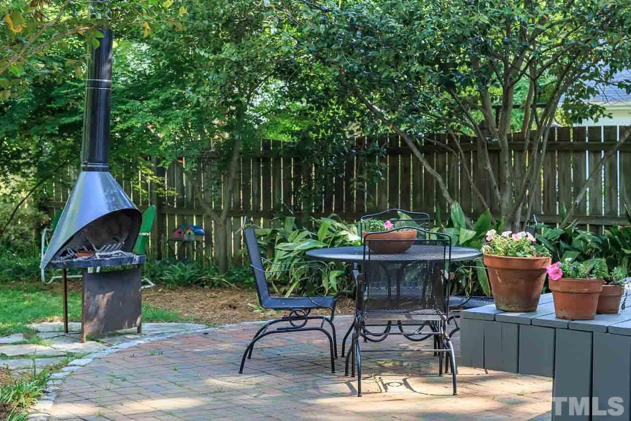 115 East Whitaker Mill Road Raleigh, NC 27608 - Photo 22 of 24 a backyard of a house with table and chairs