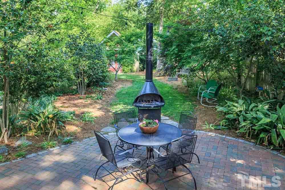 115 East Whitaker Mill Road Raleigh, NC 27608 - Photo 23 of 24 a backyard of a house with table and chairs in a patio