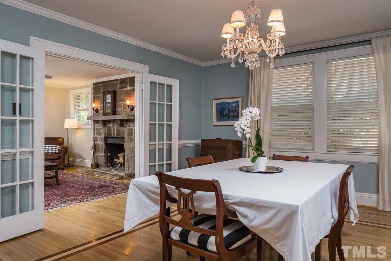 115 East Whitaker Mill Road Raleigh, NC 27608 - Photo 6 of 24 a view of a dining room with furniture and chandelier