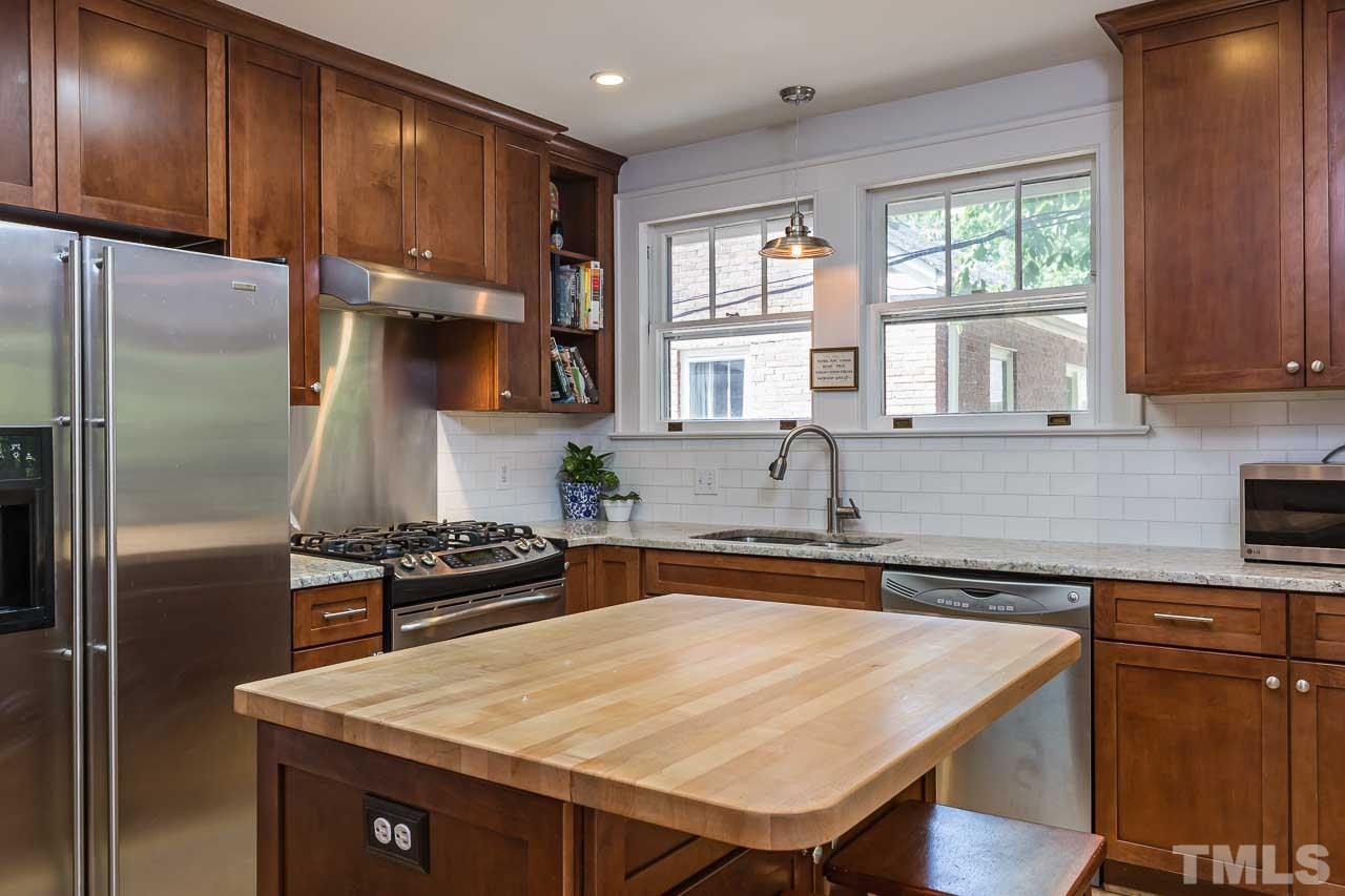 115 East Whitaker Mill Road Raleigh, NC 27608 - Photo 8 of 24 a kitchen with a stove a sink and a refrigerator