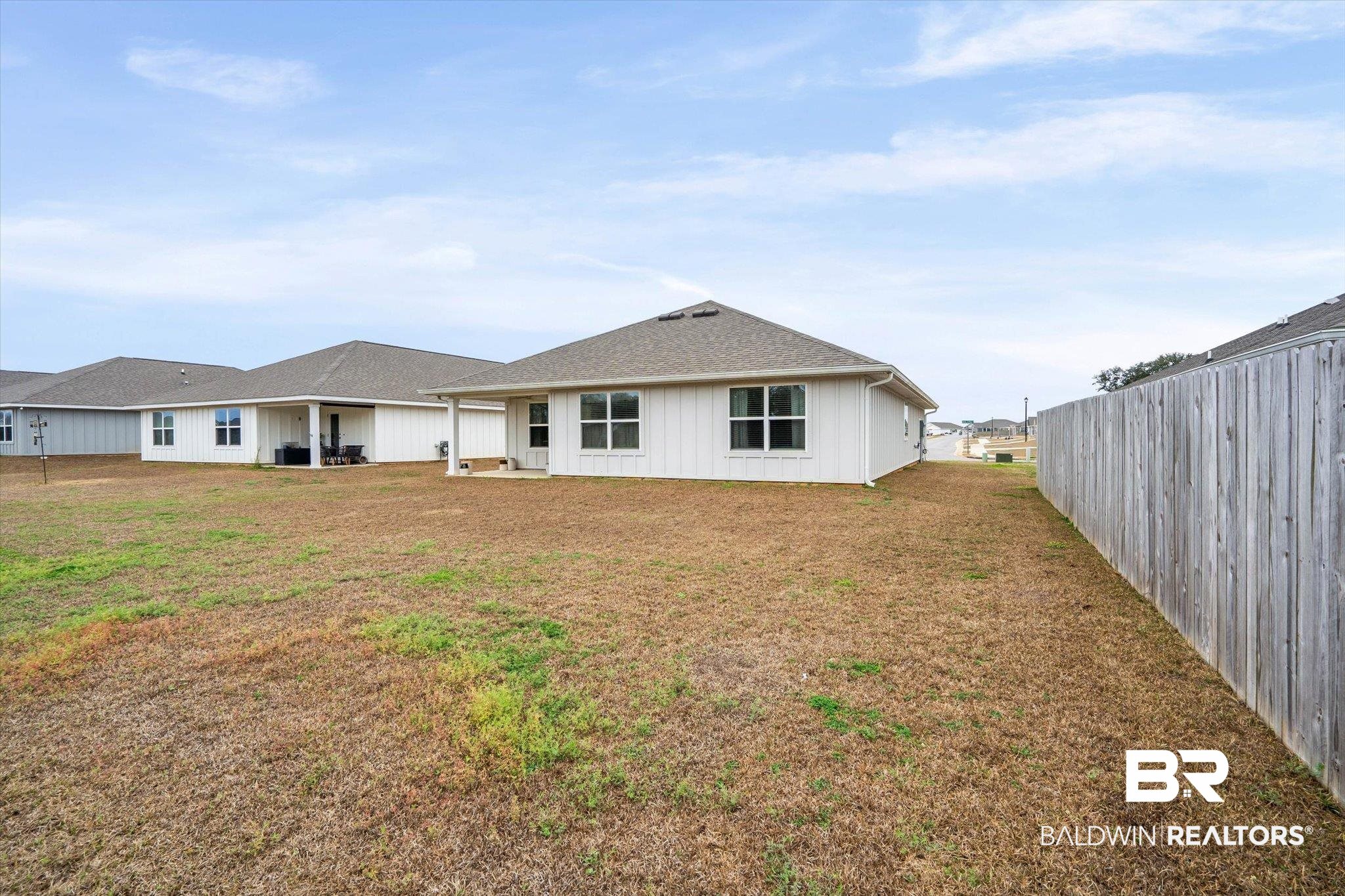 17041 Muse Street Loxley, AL 36551 - Photo 28 of 44 Back of property with a patio, a yard, and roof with shingles
