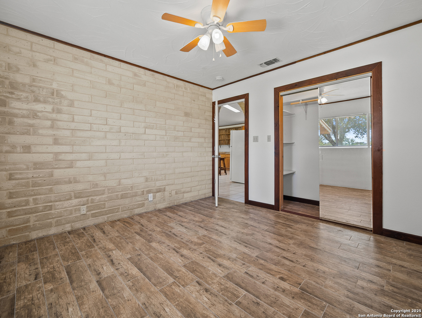 710 Chipman Lane Bandera, TX 78003 - Photo 14 of 42 a view of an empty room with window and wooden floor