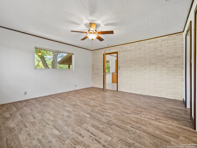 a view of empty room with wooden floor