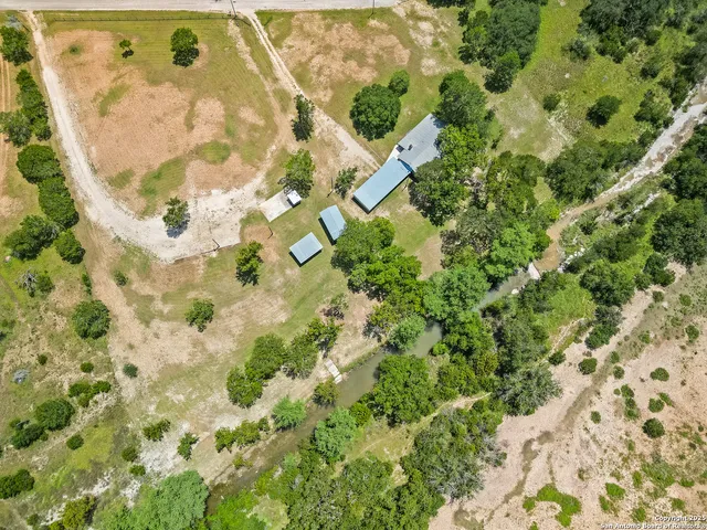 an aerial view of residential houses with yard
