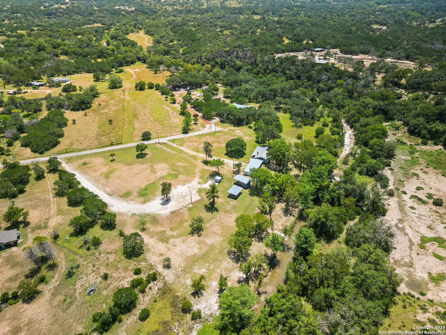 710 Chipman Lane Bandera, TX 78003 - Photo 37 of 42 an aerial view of residential houses with yard