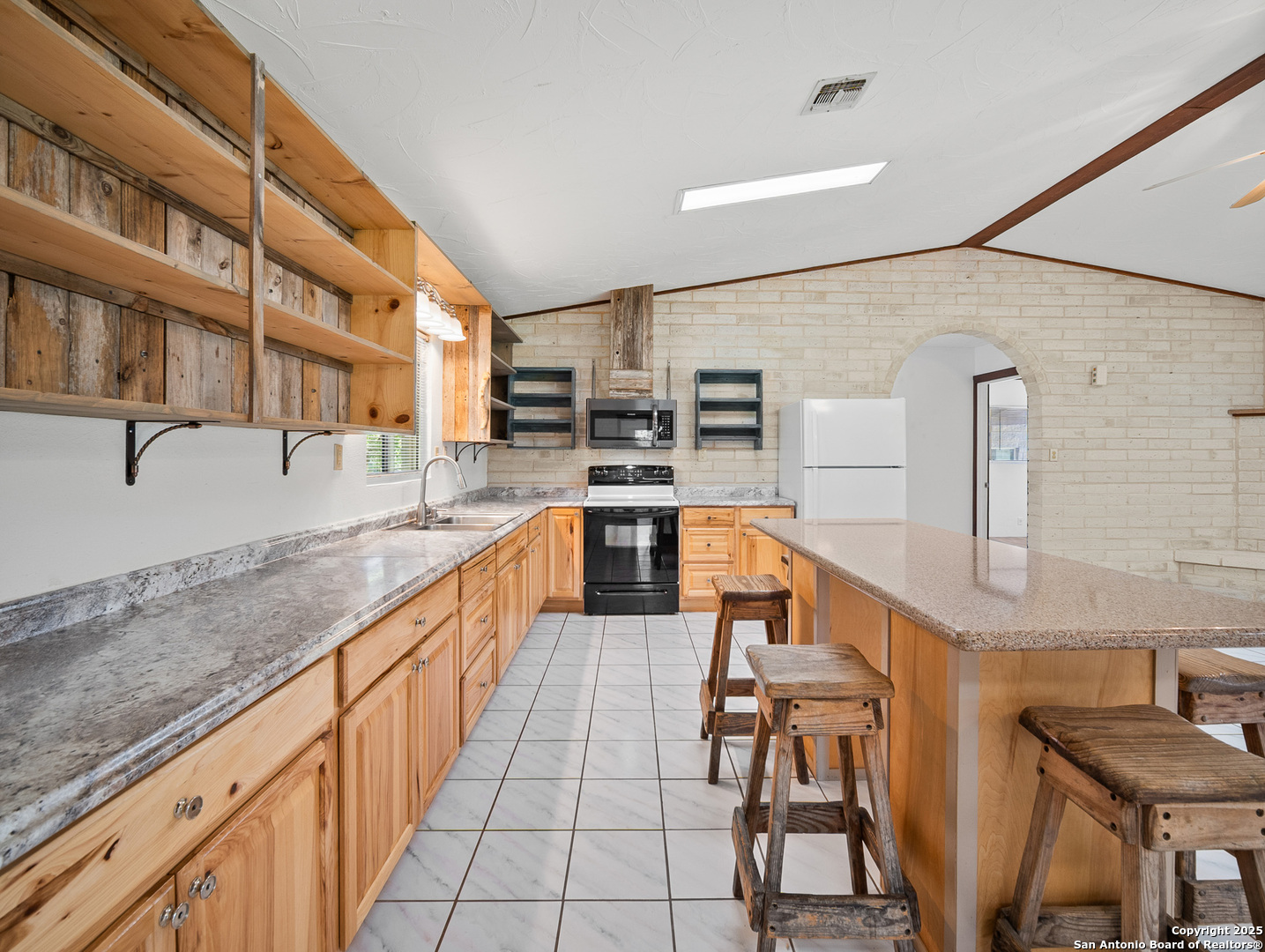 710 Chipman Lane Bandera, TX 78003 - Photo 7 of 42 a kitchen with stainless steel appliances granite countertop a sink and cabinets