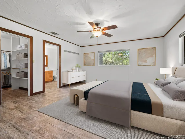 a bedroom with a bed and ceiling fan