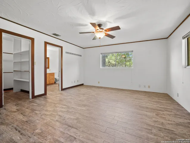 an empty room with closet and windows