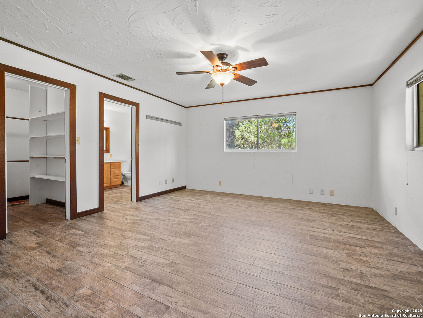 710 Chipman Lane Bandera, TX 78003 - Photo 10 of 42 an empty room with closet and windows