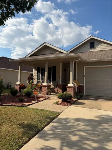 a view of the house with backyard space and garden