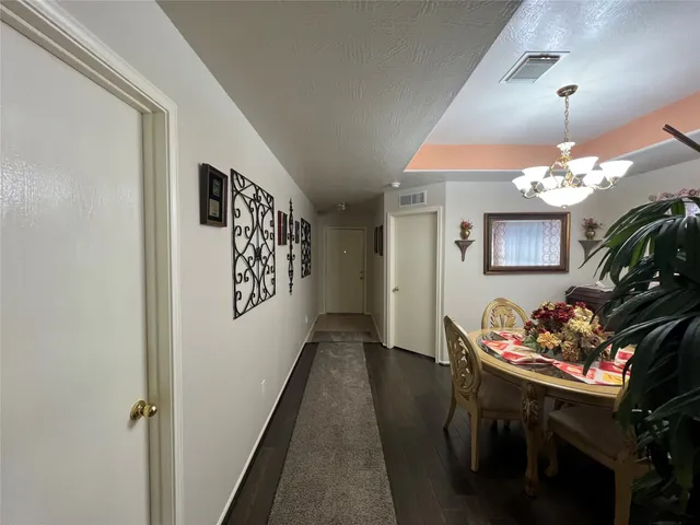 a kitchen with a table chairs and a refrigerator