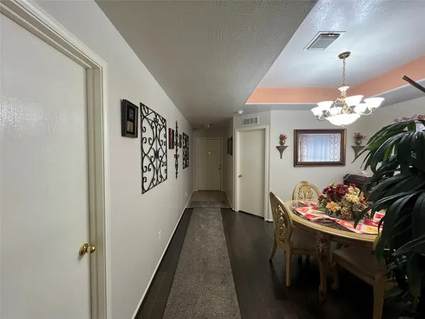a kitchen with a table chairs and a refrigerator