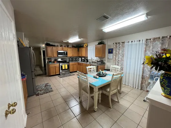 a kitchen with stainless steel appliances granite countertop a refrigerator and a stove