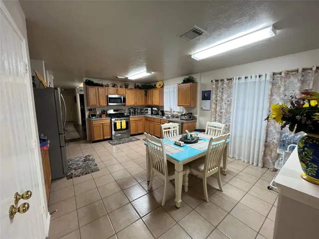 a kitchen with stainless steel appliances granite countertop a refrigerator and a stove